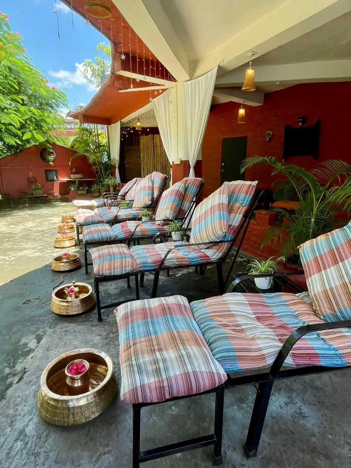 Foot treatment terrace with reclining chairs and brass foot bowls
