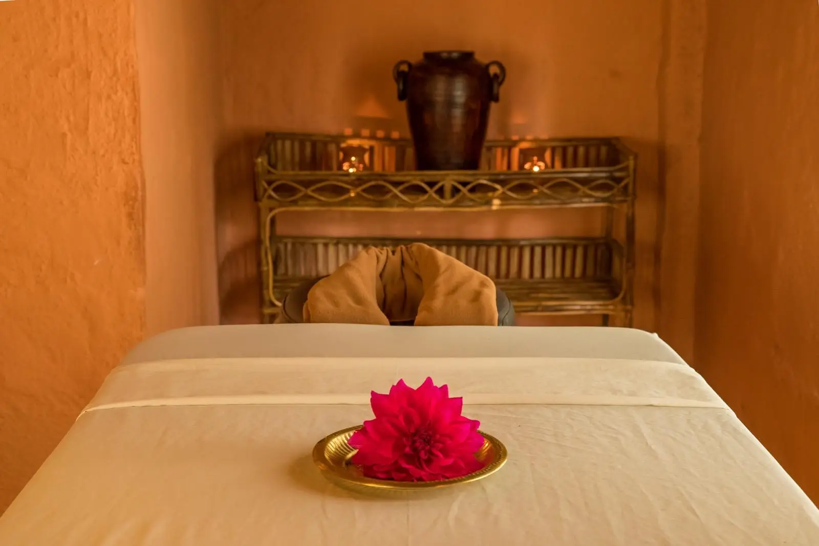 Massage bed prepared with a fresh lotus flower